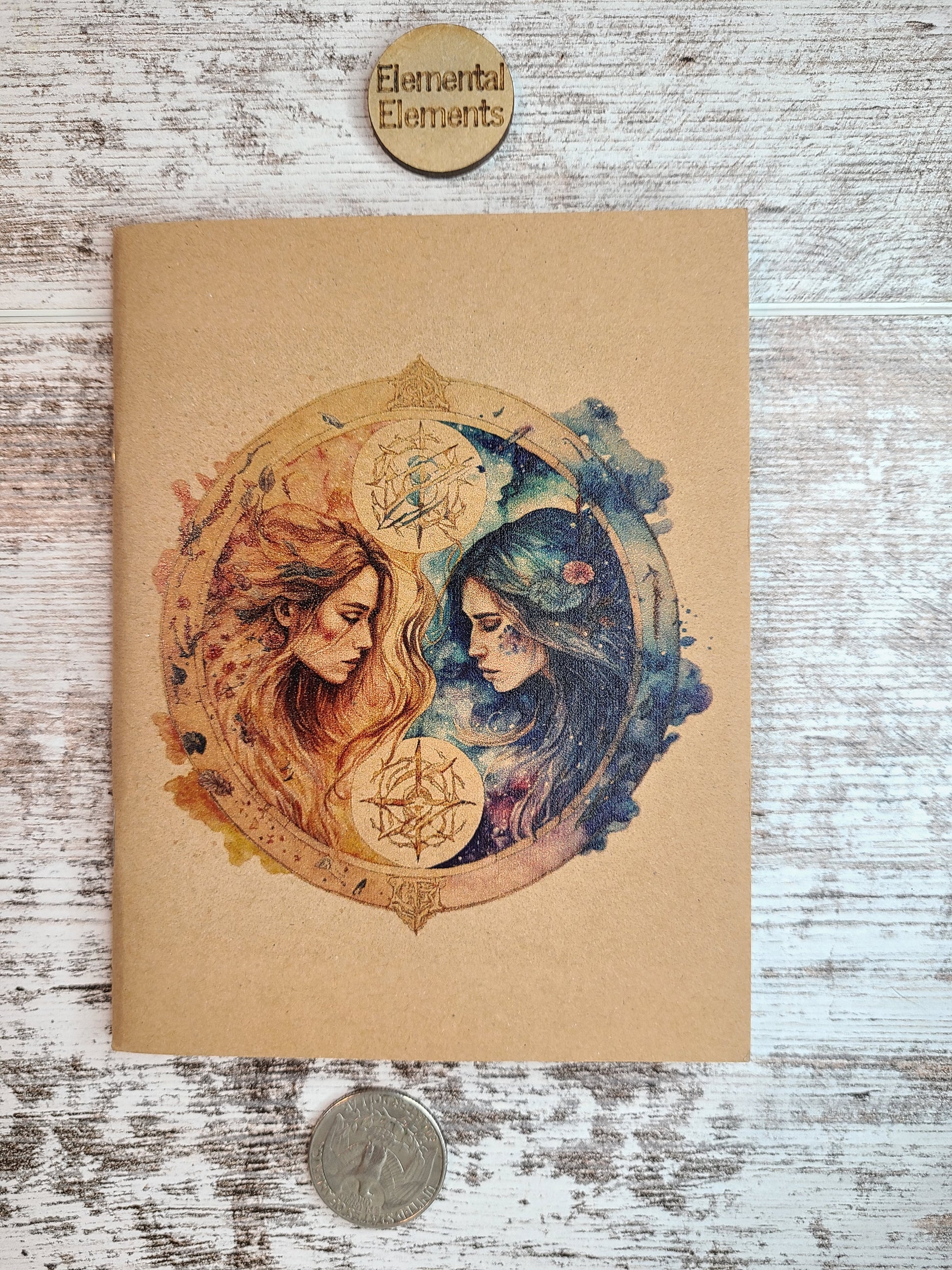 Gemini journal two humans with long hair facing each other. The left person is red and orange. The right person is blue and green. They both have flowing long hair surrounded by a circle with associated colors peeking out like clouds on each side.