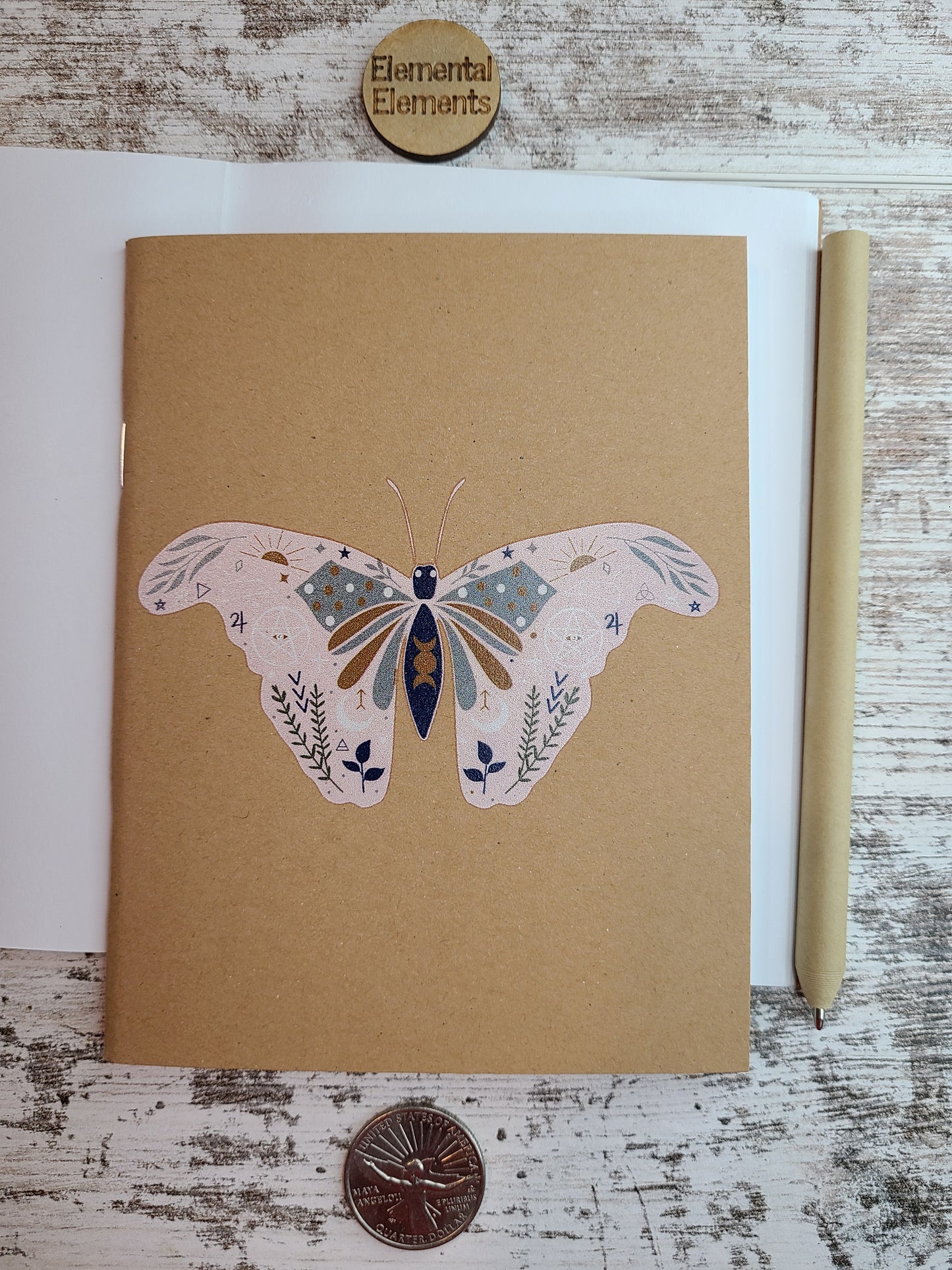 Butterfly moth with leaves, triple moon goddess, other shapes and symbols in pink, brown, green, and blue colors.