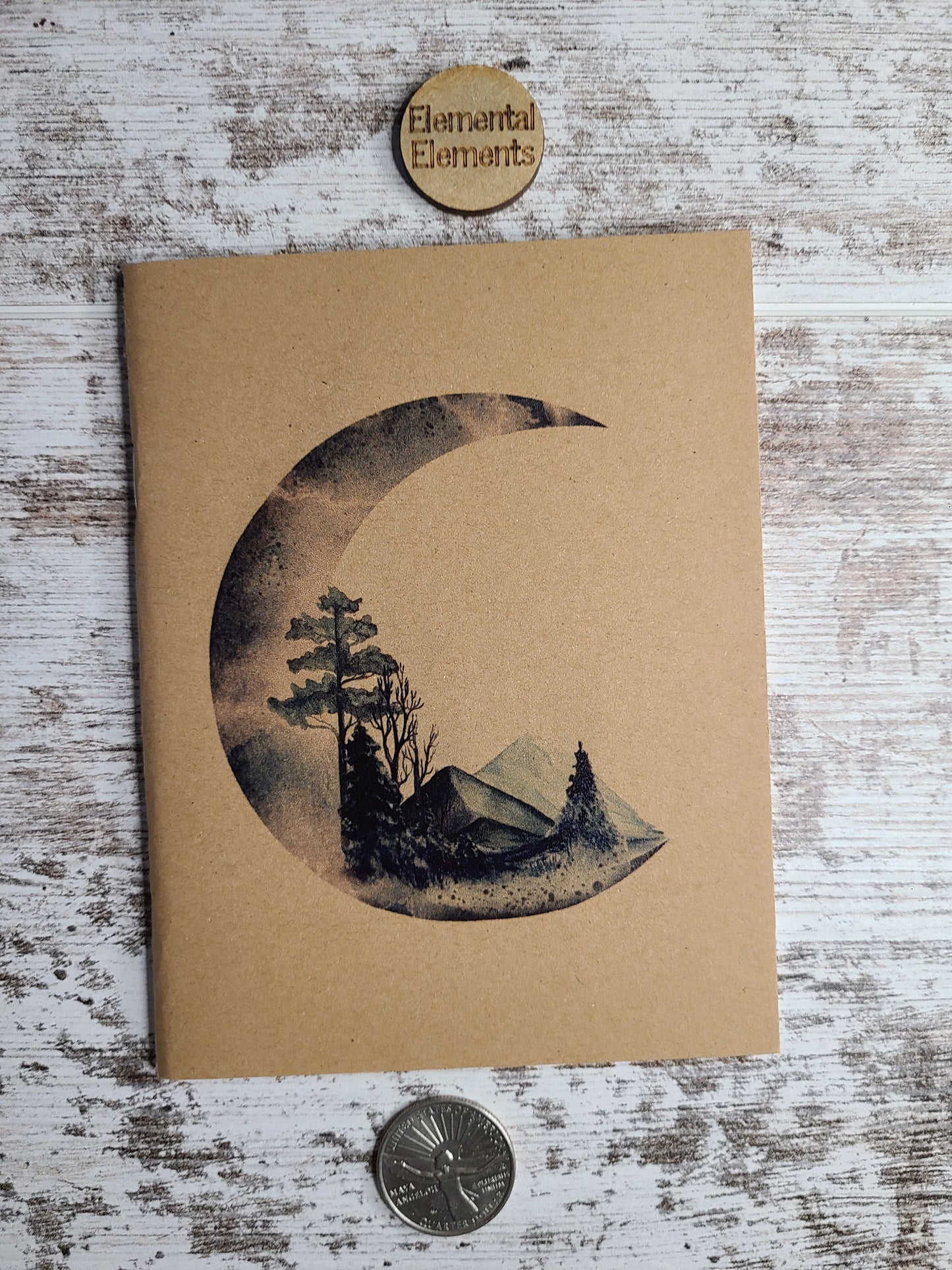 Crescent Moon with trees, prairie, boulders, and mountains.