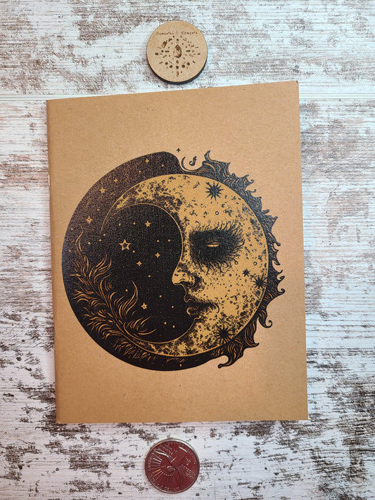 Dark crescent moon with a scarecrow type eye and a black circular background. 