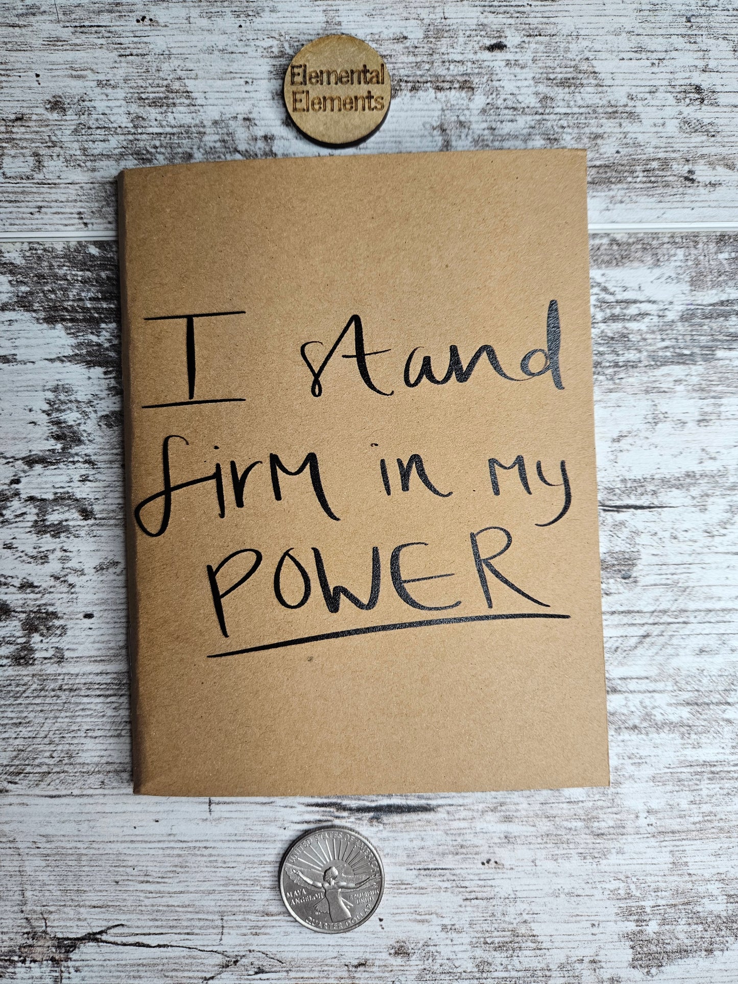 Journal with black text that says I stand firm in my power.