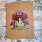 Green tree frog among three red mushrooms with eyes in them and stars and galaxies surround.