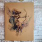 Sagittarius zodiac journal centaur holding a bow and arrow with blue, pink, purple, green, brown, red, and black colors.