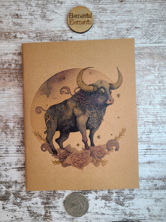Taurus zodiac journal bull standing on a flower arch with a full moon in the background.